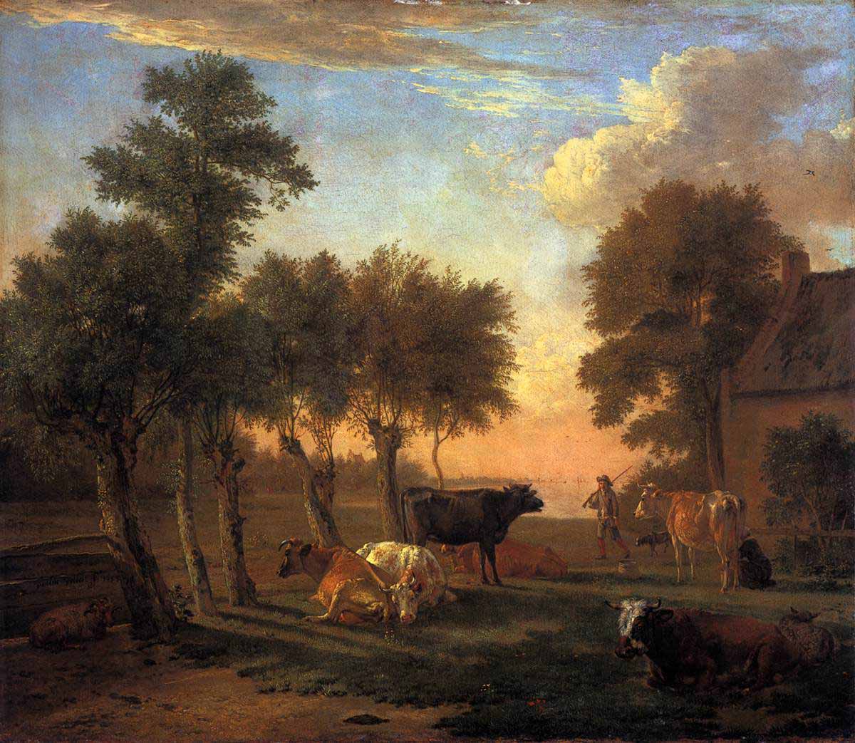 Cows in a meadow near a farm